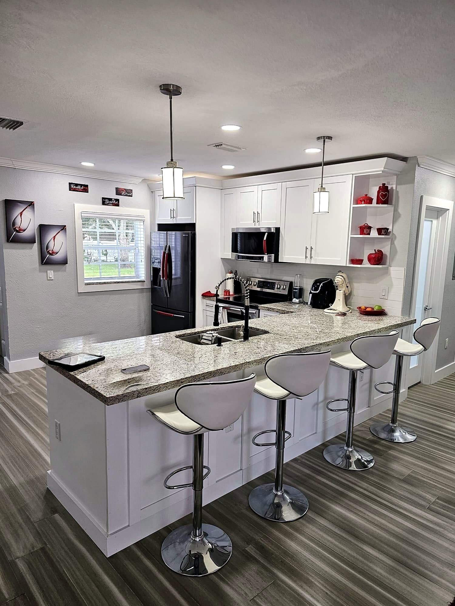 Remodeled kitchen with granite countertops and island seating